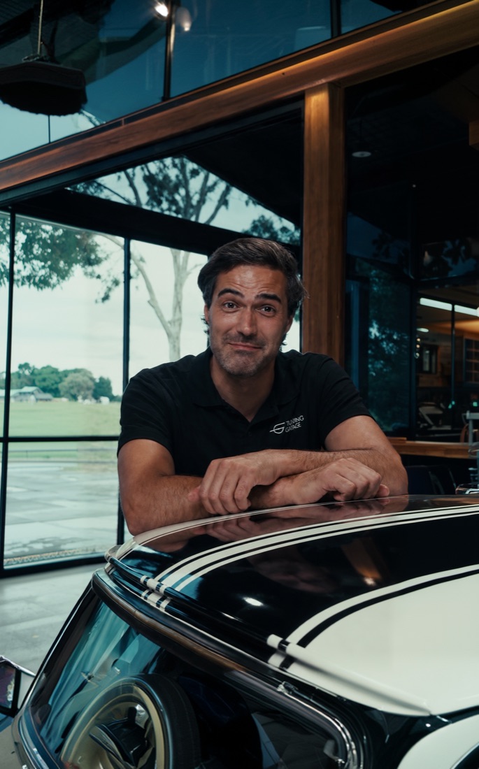 A Trading Garage specialist beside a classic car